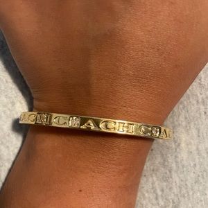 Ladies Coach brand bangle bracelet with clasp opening/closing.